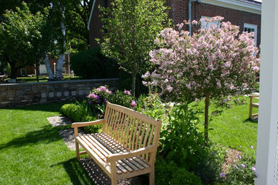 Medium sized back partial sun garden in New York with a garden path and mulch.