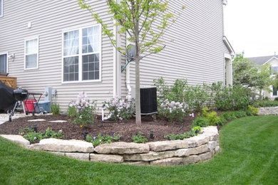 This is an example of a large traditional full sun backyard concrete paver landscaping in Chicago.
