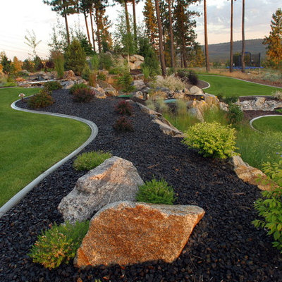 Inspiration for a large contemporary backyard mulch landscaping in Seattle.