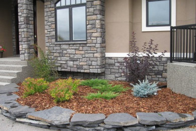 Photo of a traditional stone landscaping in Calgary.