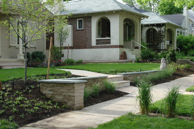 Design ideas for a mid-sized traditional partial sun front yard stone retaining wall landscape in Denver.