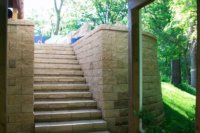 Design ideas for a backyard stone retaining wall landscape in Chicago.