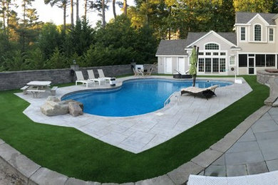Inspiration for a large traditional backyard concrete paver water fountain landscape in Boston.