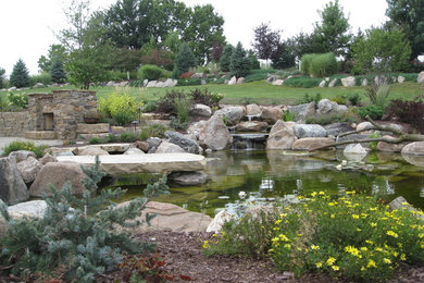 This is an example of a huge backyard concrete paver pond in Omaha.