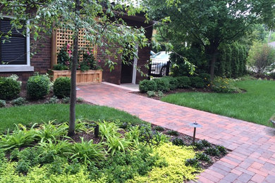 Photo of a craftsman partial sun backyard brick landscaping in Chicago for summer.