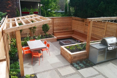 This is an example of a small contemporary full sun backyard landscaping in Toronto.