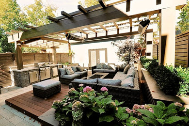 Inspiration for a small modern backyard landscaping in Toronto with decking.