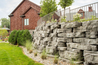 Photo of a mid-sized rustic backyard concrete paver retaining wall landscape in Detroit for summer.