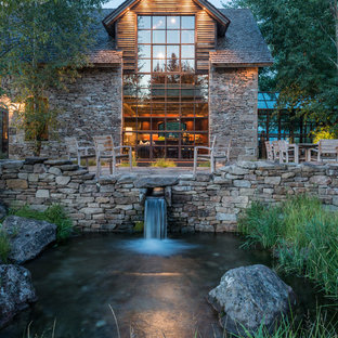 Photo of a rustic garden in Other with a water feature.