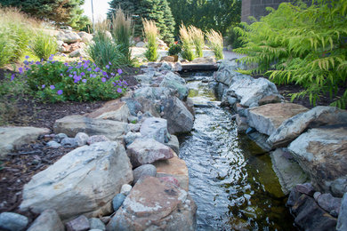 Rustic Mountain stream flowing into lakeside patio