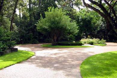 Photo of a large traditional shade front yard concrete paver landscaping in Houston for spring.
