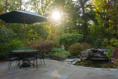 Design ideas for a mid-sized transitional partial sun backyard landscaping in Cleveland.