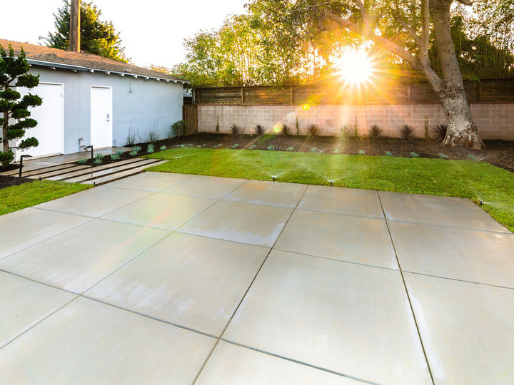 Picture of a sizable, formal, shaded backyard in the summer.