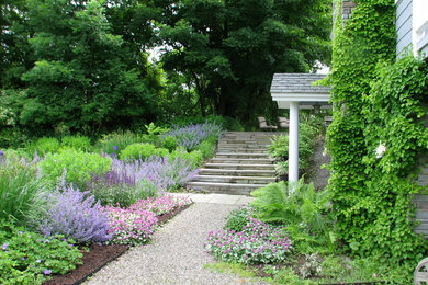 This is an example of a mid-sized coastal full sun front yard gravel garden path in New York.
