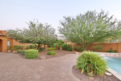 Design ideas for a large traditional drought-tolerant and partial sun backyard concrete paver landscaping in Phoenix.