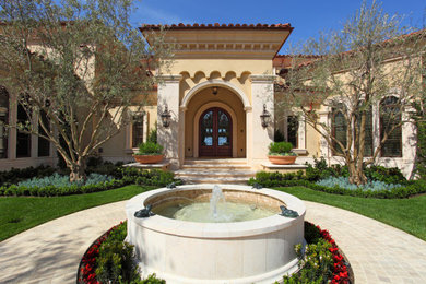 Photo of a large mediterranean full sun front yard stone landscaping in Orange County.
