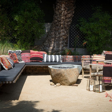Seating area with large built-in bench seating and boulder fire pit