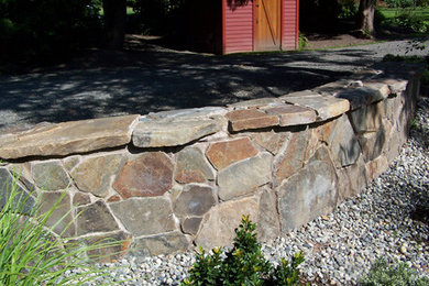 Photo of a mid-sized rustic partial sun side yard stone driveway in Seattle.