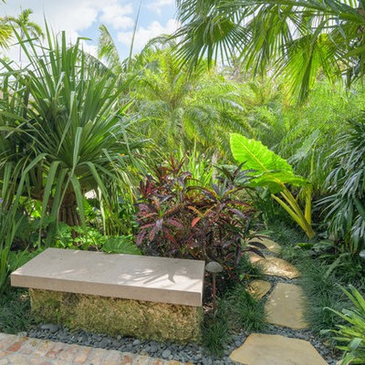 Design ideas for a mid-sized tropical full sun brick landscaping in Miami.
