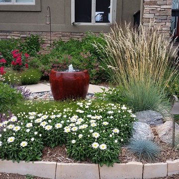 Self contained water feature as a focal point among plantings