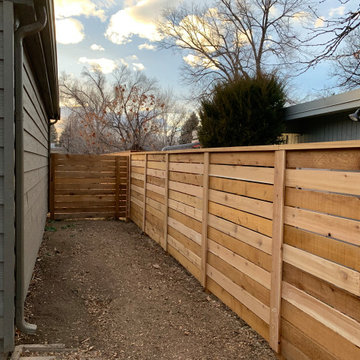 Semi Private Horizontal Fence w/ 1/2 picket spacing, post covers and top cap.