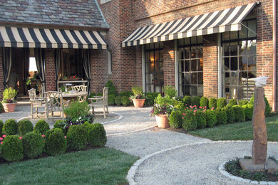 This is an example of a small traditional partial sun courtyard gravel landscaping in New York.