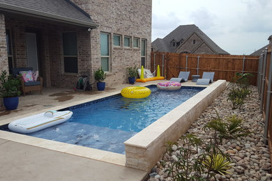This is an example of a large tropical full sun backyard gravel landscaping in Dallas for summer.