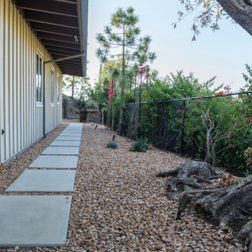 Sideyard with concrete pavers and gravel