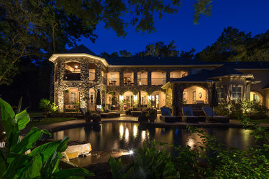 This is an example of a large traditional backyard landscaping in Houston.