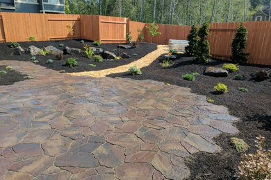 Inspiration for a large classic back xeriscape full sun garden in Seattle with natural stone paving.