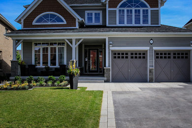 Inspiration for a small modern front driveway full sun garden for summer in Toronto with a potted garden and concrete paving.
