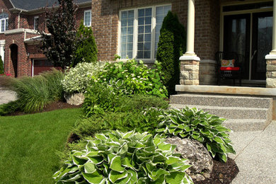 Inspiration for a large modern full sun front yard concrete paver driveway in Toronto for summer.