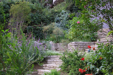 Design ideas for a large drought-tolerant and full sun backyard stone retaining wall landscape in Los Angeles.