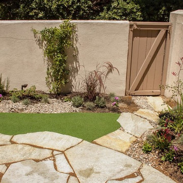 Small Backyard Space with Flagstone and Artificial Grass