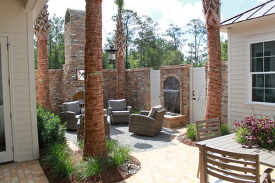 Example of a small beach style courtyard brick patio design in New Orleans