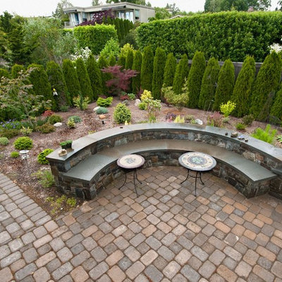 Inspiration for a large traditional backyard stone formal garden in Seattle.