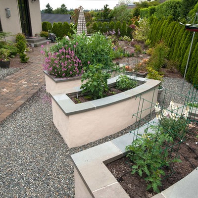 This is an example of a large traditional backyard stone landscaping in Seattle.