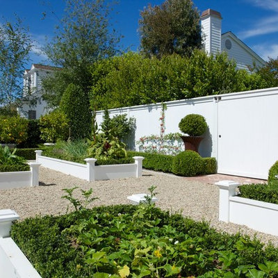 This is an example of a traditional full sun backyard gravel raised garden bed in Los Angeles.