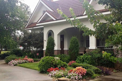Bild på en mellanstor eklektisk uppfart framför huset, med en trädgårdsgång
