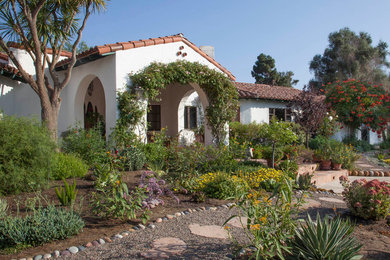 Inspiration for a large mediterranean full sun front yard gravel garden path in San Diego.