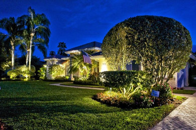 Photo of a huge traditional partial sun front yard driveway in Miami.