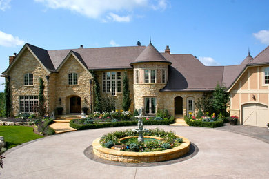Photo of a huge traditional full sun front yard stone landscaping in Calgary for summer.