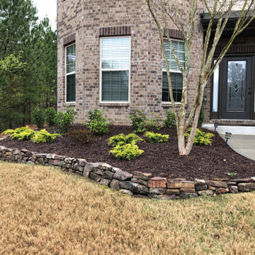 Stacked stone border with new shrubs