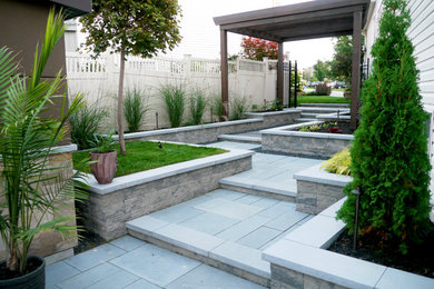 This is an example of a mid-sized modern backyard stone garden path in Ottawa for summer.