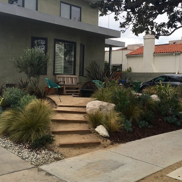 Stepped, Drought Tolerant Front Patio with Firepit and Seating