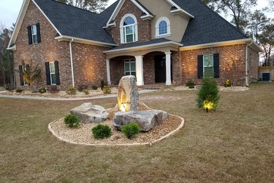 This is an example of a mid-sized traditional front yard gravel landscaping in Atlanta.