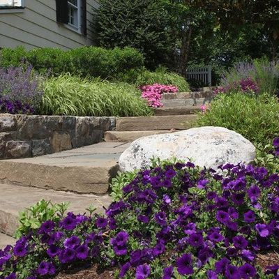 Inspiration for a large traditional full sun backyard stone landscaping in New York.