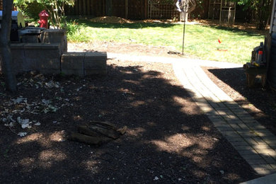 Design ideas for a mid-sized southwestern partial sun backyard stone water fountain landscape in Chicago for summer.