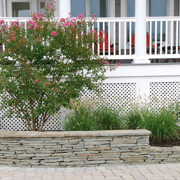 Stone retaining wall with Crape Myrtle and grasses
