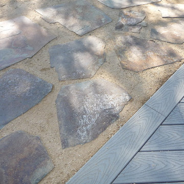 Stone set in decomposed granite adjacent to Trex